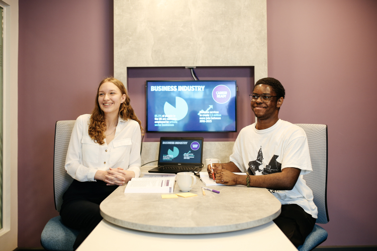 Two students sitting at a table
